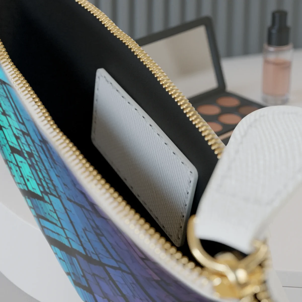 Close-up of the inside of the mini clutch bag showing the pocket and edge of the colorful mosaic design.