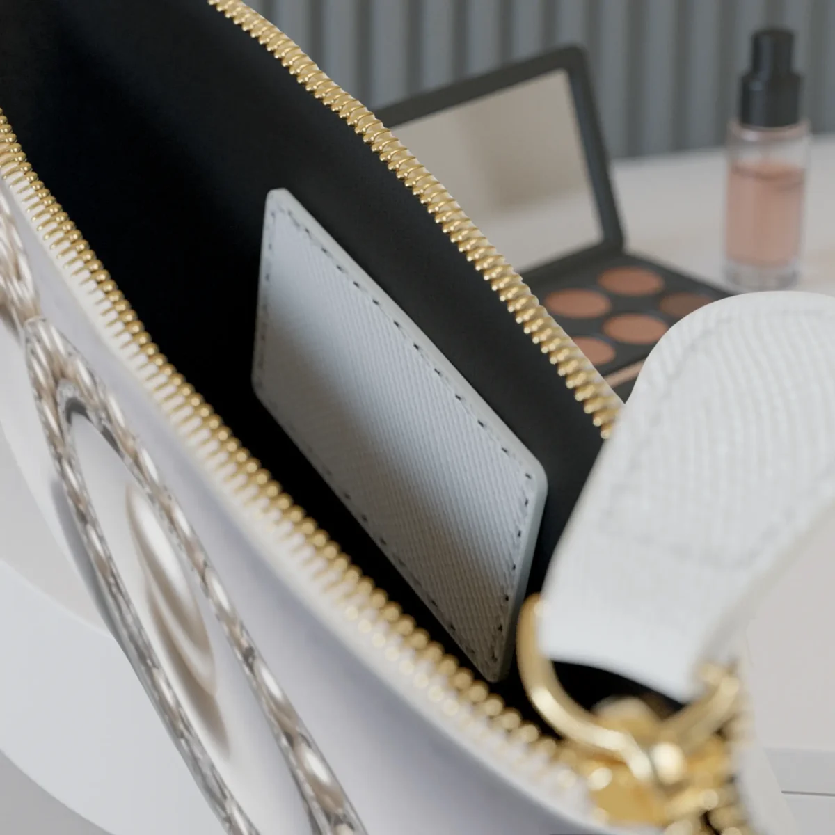 Close-up of the inside of the mini clutch bag showing the inner pocket and part of the accessory-themed design.
