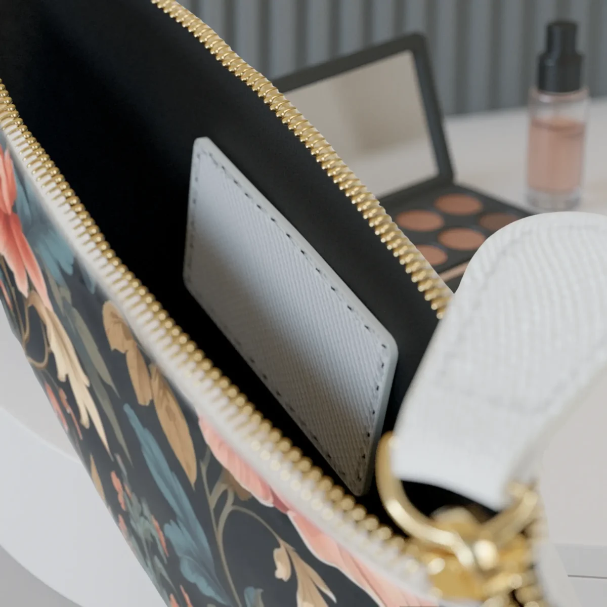 Close-up of the inside of the mini clutch bag showing the inner pocket and edge of the floral arabesque print.