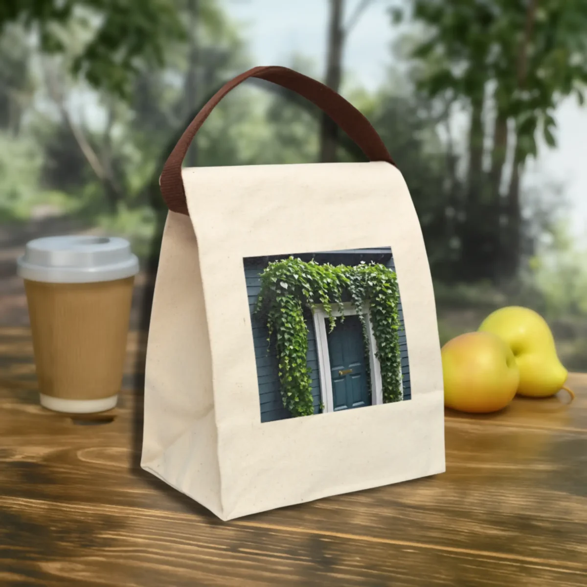 Canvas lunch bag with ivy-covered doorway print placed outdoors on a wooden table.