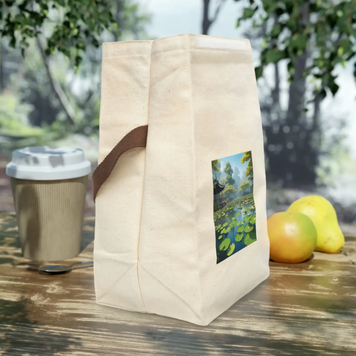Side view of a canvas lunch bag with a printed lotus pond and pagoda scene.