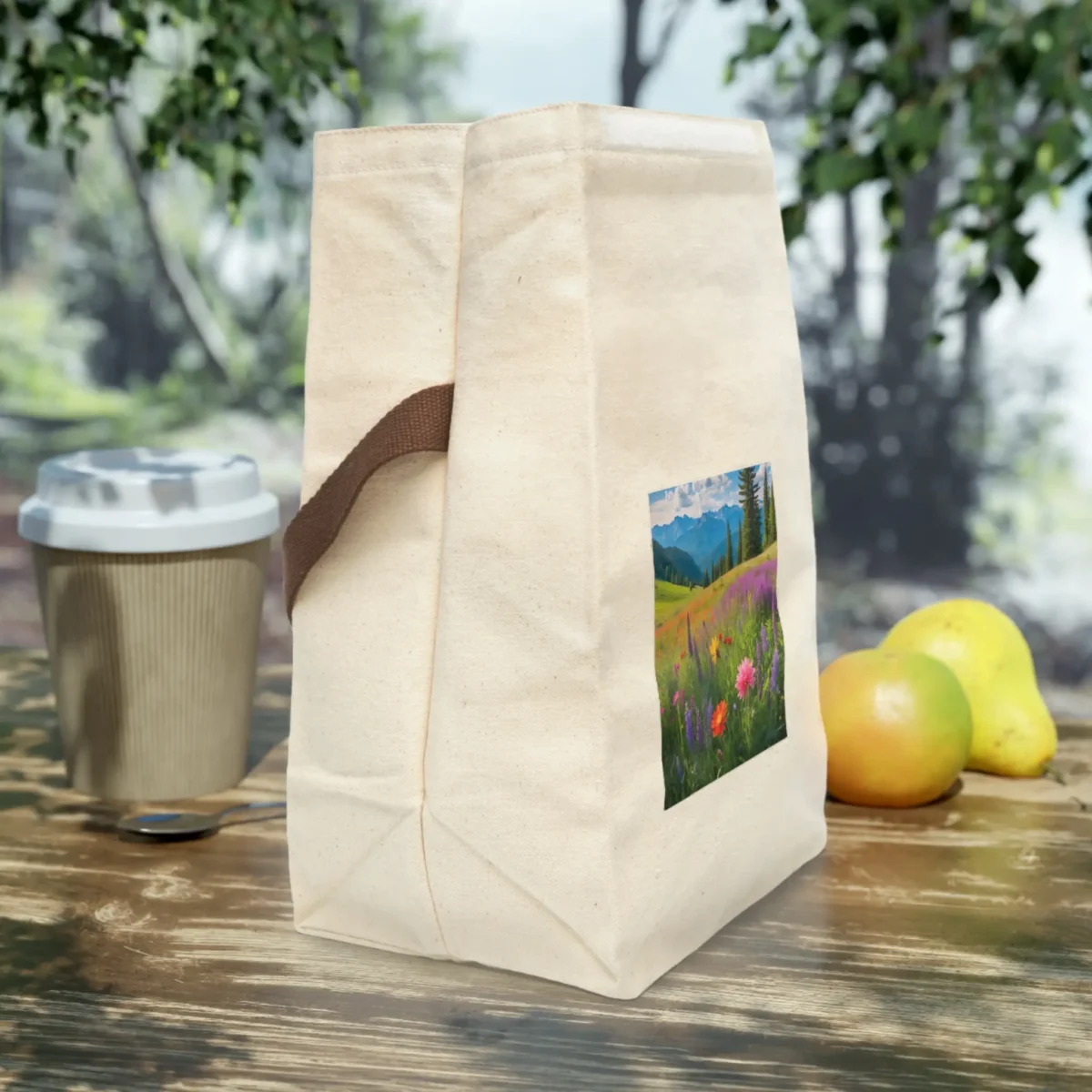 Side view of a canvas lunch bag featuring a colorful mountain meadow print with wildflowers.