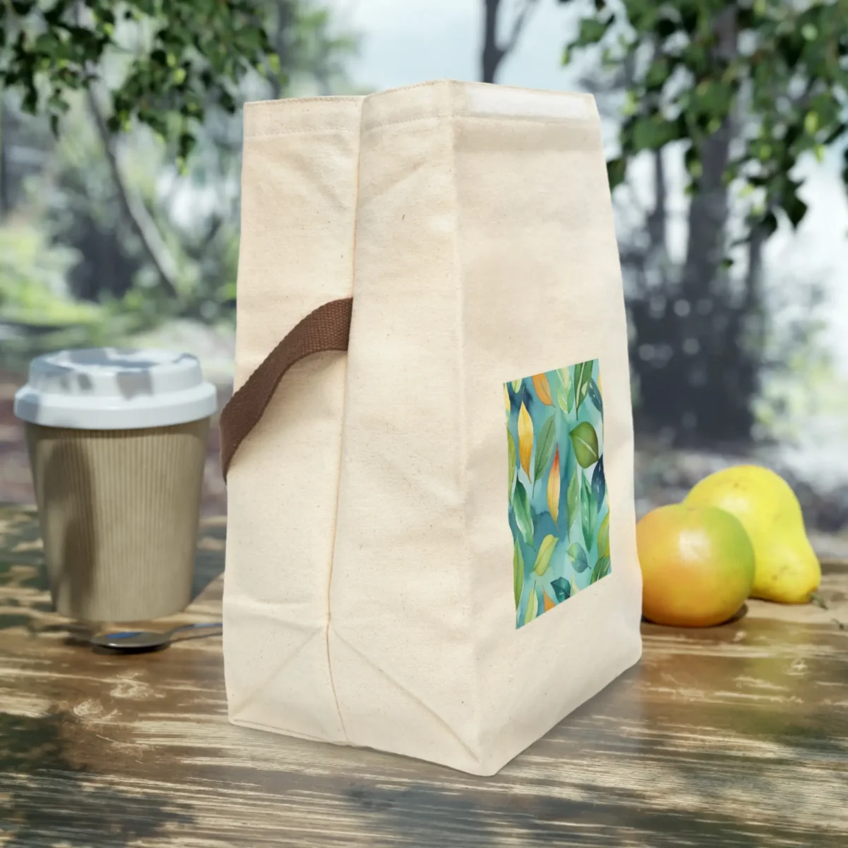 Natural canvas lunch bag with brown strap and vertical watercolor leaves print