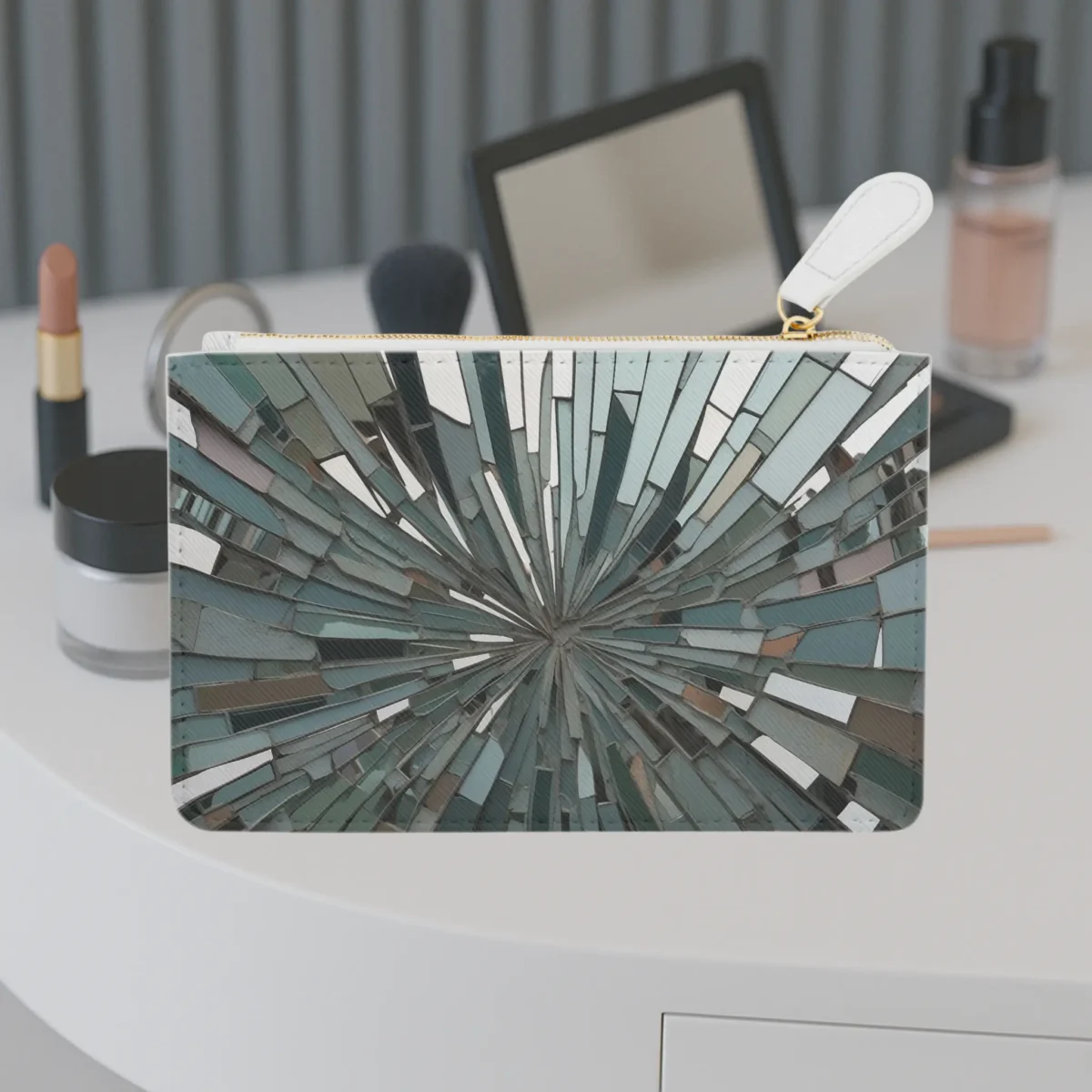 Mini clutch bag with abstract fragmented mirror design placed on a vanity