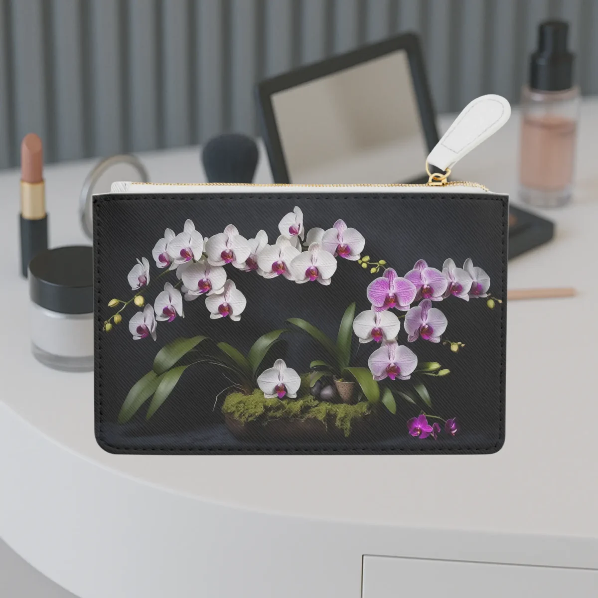 Mini clutch bag with a white and purple orchid design on a black background