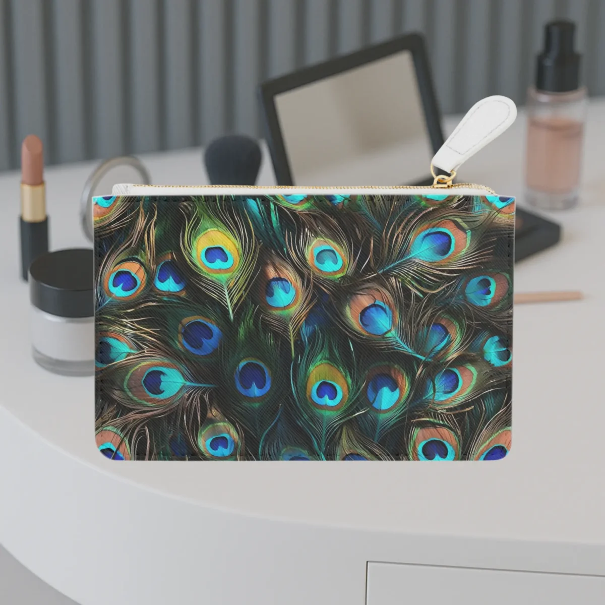 Mini clutch bag with a vivid peacock feather design in blue, green, and gold tones