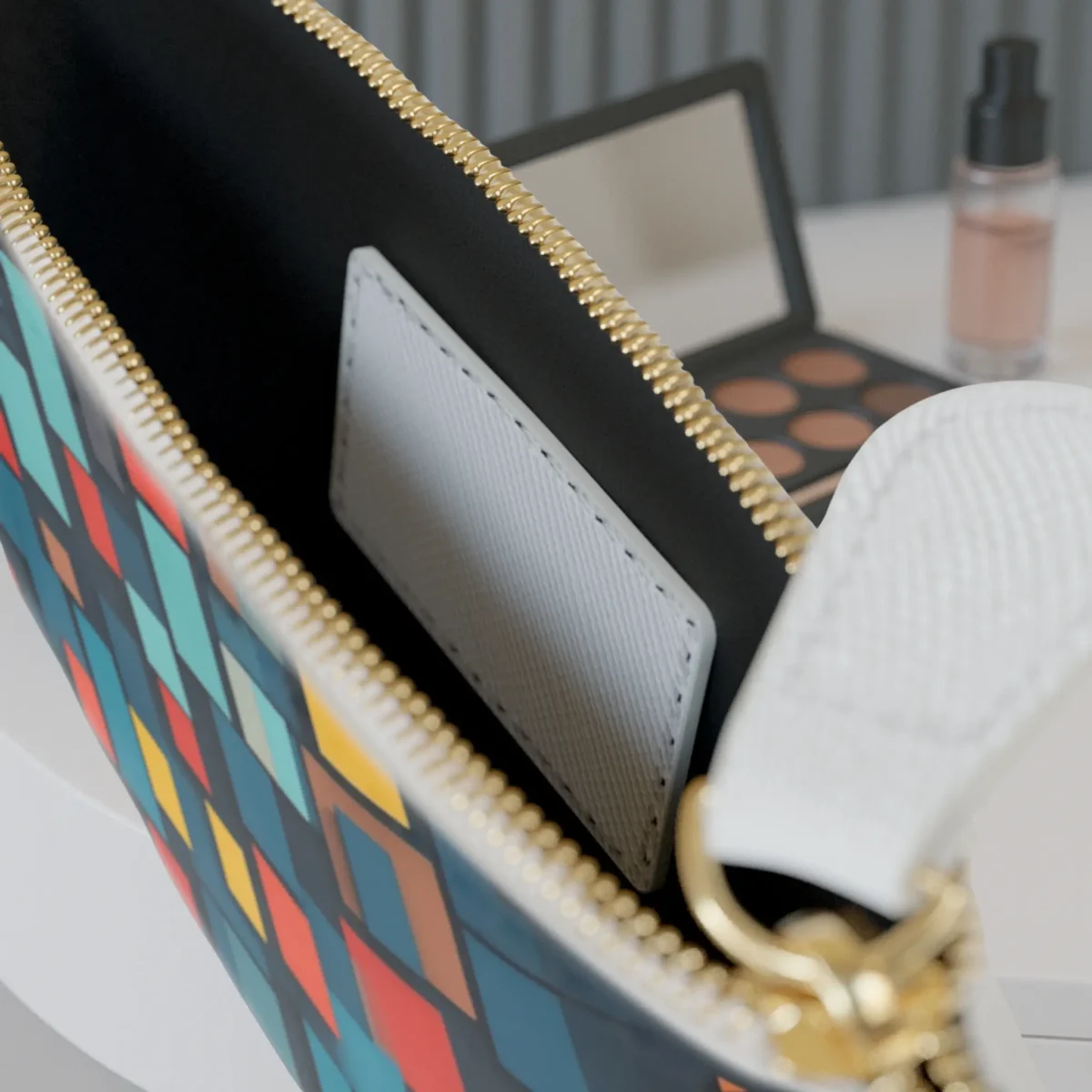 Interior view of mini clutch bag with geometric pattern and internal pocket