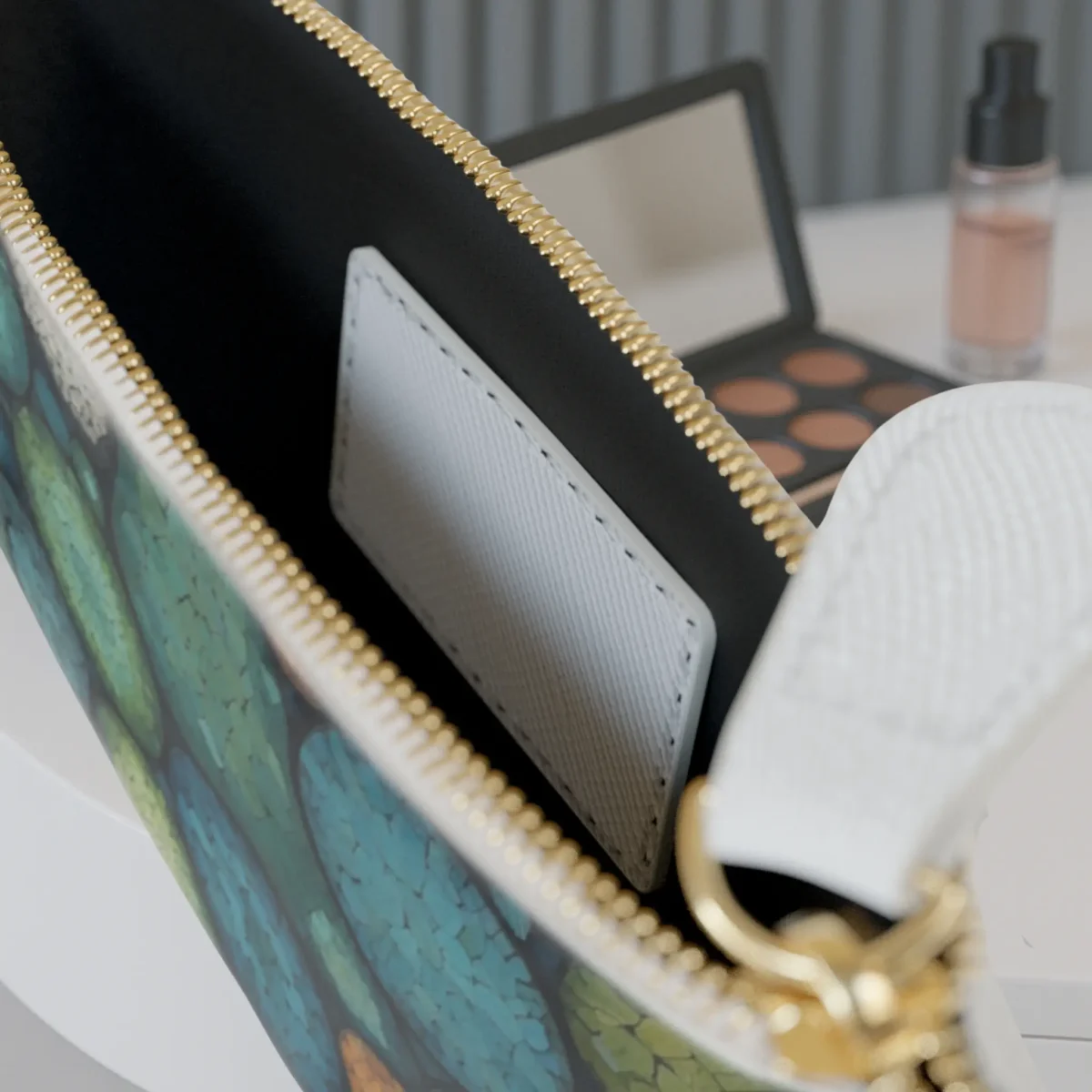 Interior of the mini clutch bag with card pocket and colorful abstract pattern visible on the edge