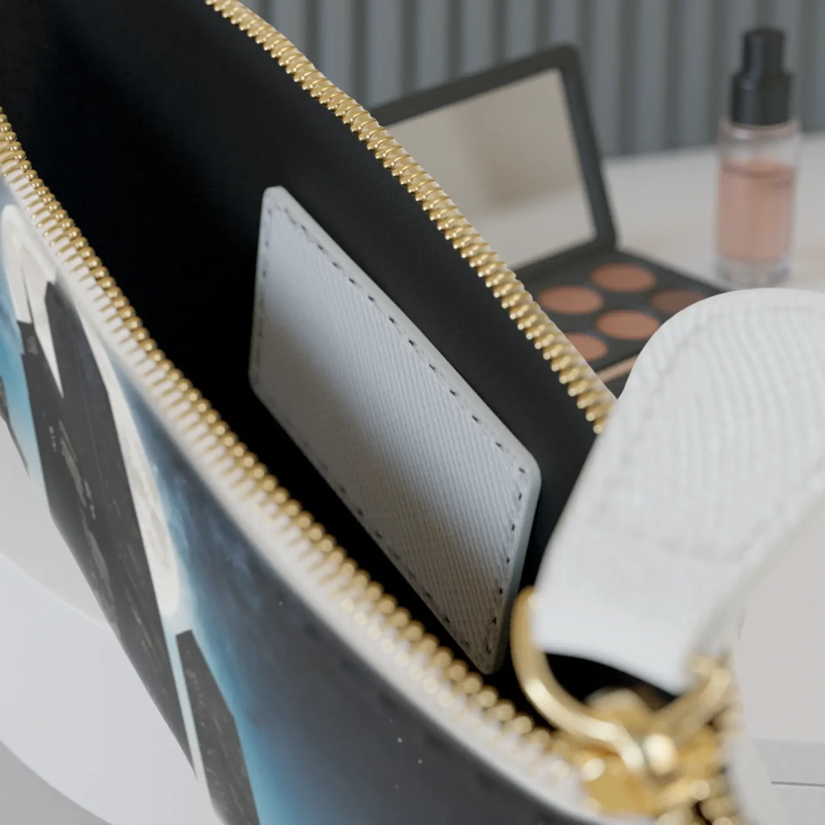 Close-up of the inside pocket of the Skyscraper mini clutch bag with visible zipper and white card slot.