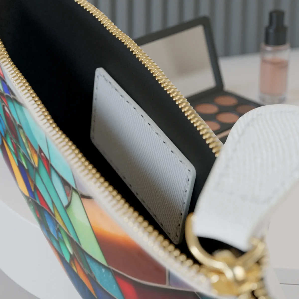 Close-up of the inside pocket of the Stained Glass mini clutch bag with visible zipper and white card slot.