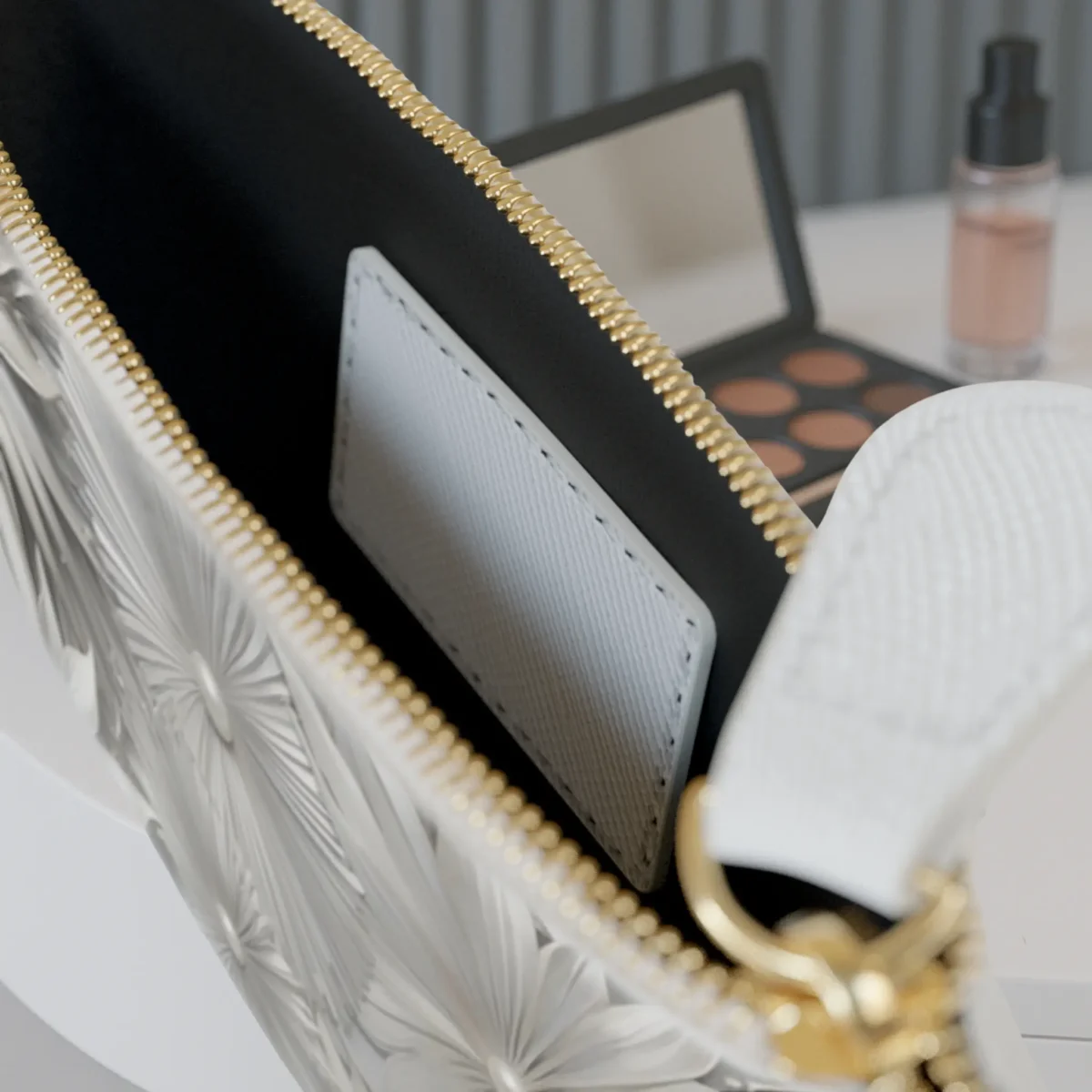 Close-up of the inside pocket of the Sunburst mini clutch bag with visible zipper and white card slot.