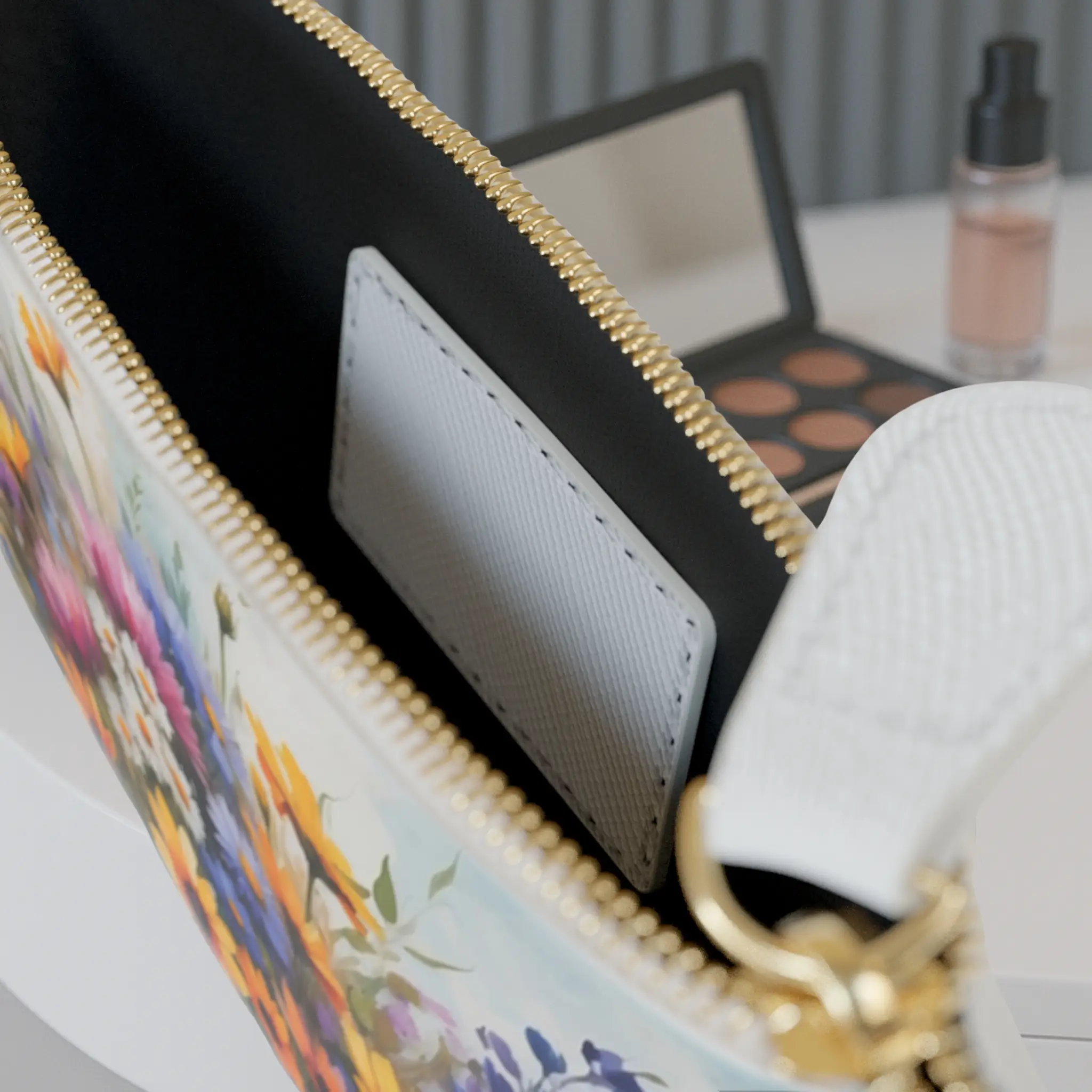 Interior view of Wildflowers mini clutch bag Close-up of the inside pocket of the Wildflowers mini clutch bag with visible zipper and white card slot.