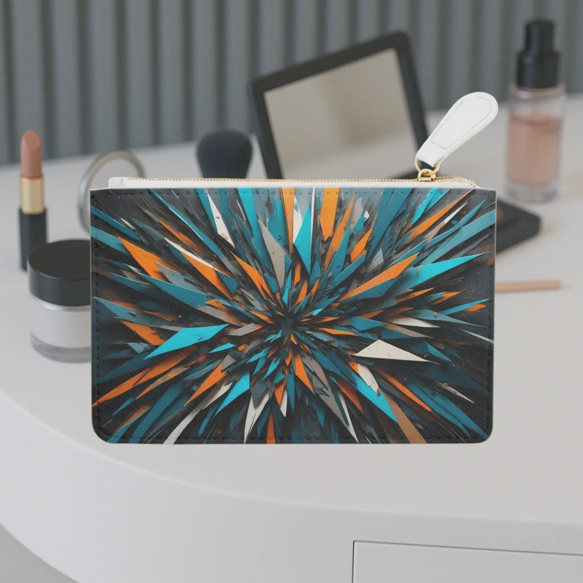 Front view of a mini clutch bag with vibrant asymmetrical shard pattern in orange, teal, and black