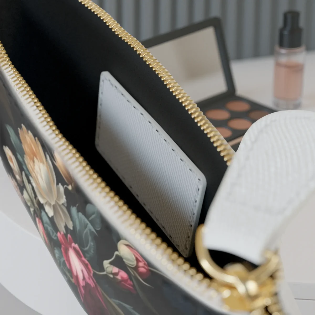 Inside view of mini clutch bag with floral print, showing internal pocket and zipper