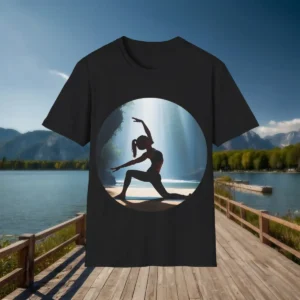 Flatlay of black t-shirt showing a yoga pose silhouette in nature with rays of light and waterfall