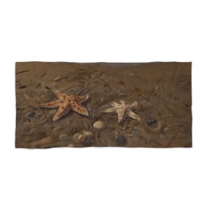 Beach towel with two starfish and rocks on a sandy shore