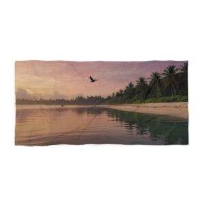 Tropical beach at sunrise with calm water and palm trees beach towel