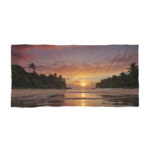 Tropical beach at sunset with palm trees and calm water beach towel