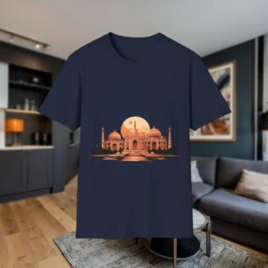 Navy blue T-shirt featuring an artistic illustration of famous landmarks with a glowing orange sunset in the background, displayed in a stylish living room.