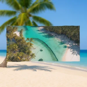Flat view of a beach towel featuring a tropical island aerial scene with clear water and palm trees