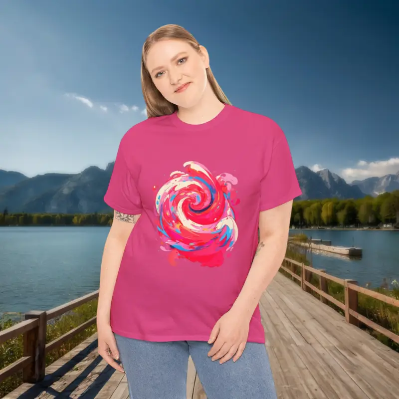 Pink Swirl T-Shirt - Scenic Mountain View Woman wearing a pink t-shirt with abstract swirl design standing on a wooden dock by a mountain lake