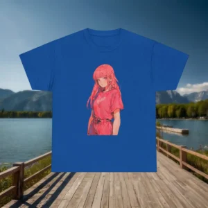 Flatlay of a blue t-shirt with a pink anime girl graphic, displayed in front of a lake and mountain background.