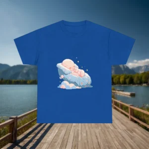 Blue baby sleeping t-shirt laid flat on a wooden dock with a scenic lake and mountain view in the background.
