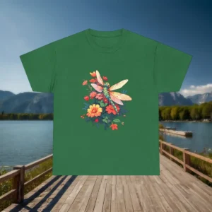 Flat lay of a green t-shirt with an elegant dragonfly surrounded by colorful garden flowers.