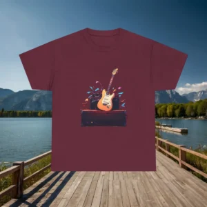 Flatlay of a maroon t-shirt with a graphic of an electric guitar and amplifier surrounded by colorful splashes.