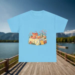 Flat blue t-shirt with hand-drawn picnic table covered in food and surrounded by flowers