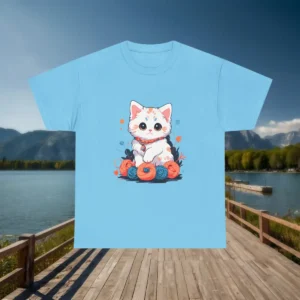 Flat lay of a light blue t-shirt with cute kitten and yarn ball design