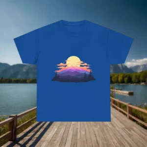Flatlay of blue t-shirt with colorful sunrise and mountain illustration