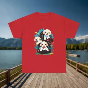 Flatlay of a red t-shirt with a design of three smiling puppies surrounded by colorful leaves and flowers.