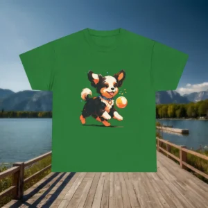 Flatlay of a green t-shirt featuring a cheerful black and white cartoon puppy with an orange ball.