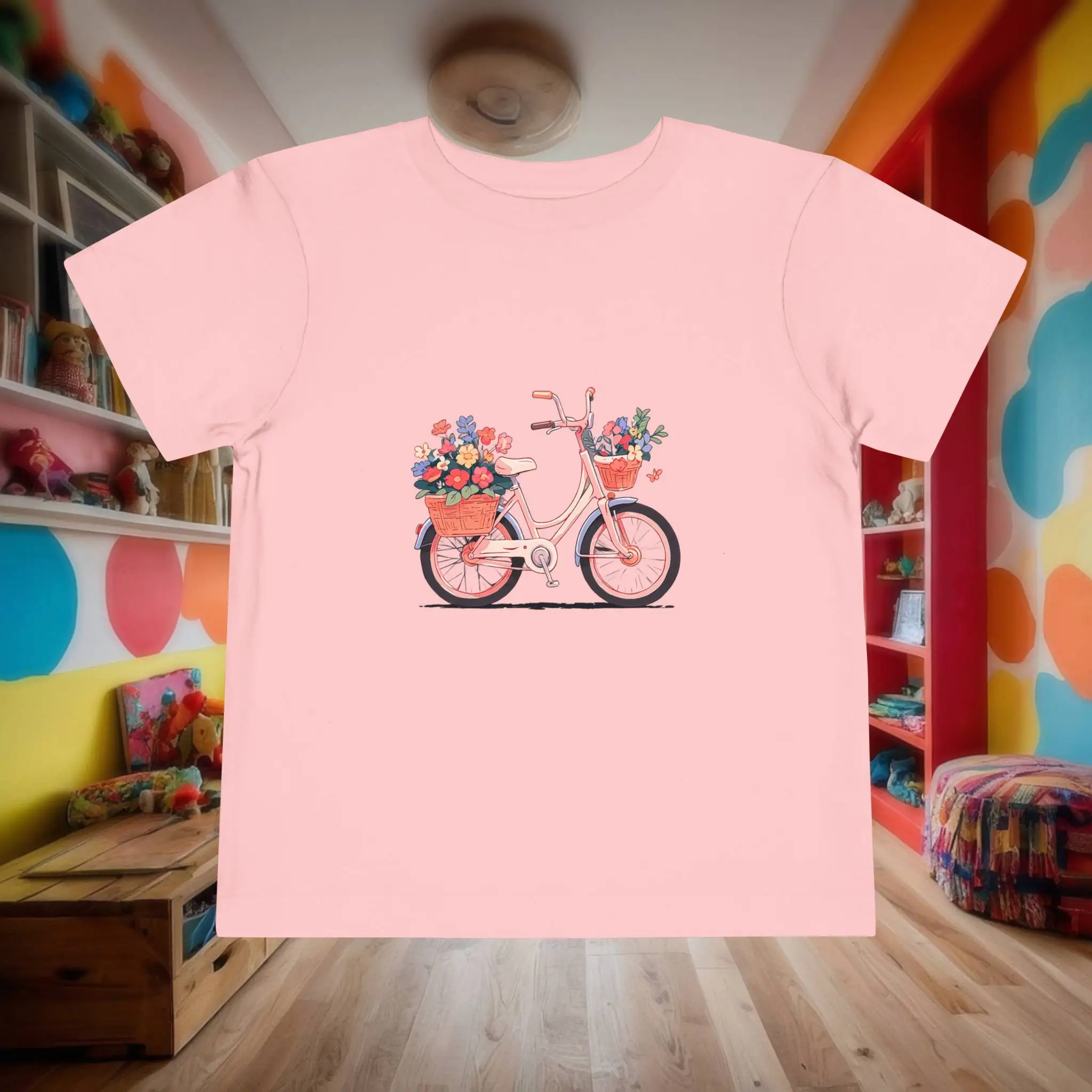 Pink toddler t-shirt with bike and flowers design Flat lay of pink toddler t-shirt with a bicycle and flower baskets print