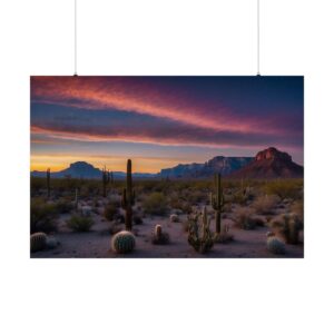 Desert landscape with cacti at sunset, mountains in the background, and vibrant clouds in shades of pink and purple.