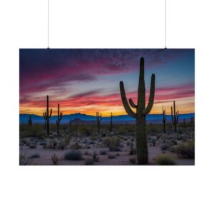 Desert landscape with tall cacti silhouetted against a vibrant sunrise sky in shades of red, pink, and blue.