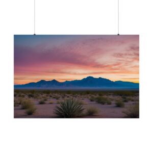 Expansive desert landscape with scattered vegetation, distant mountains, and a colorful sky during sunset.