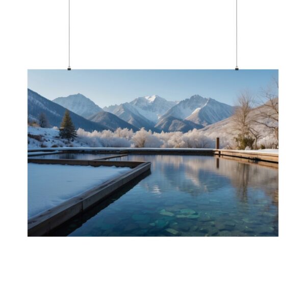 Serene mountain lake with snow-covered surroundings, clear water, and reflections of snowy peaks under a bright blue sky.