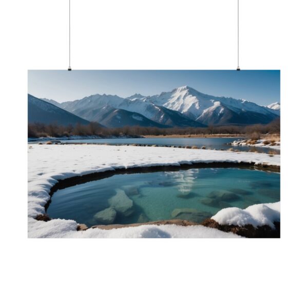 Snow-covered mountain landscape with a clear pool of water reflecting snowy peaks under a bright blue sky.