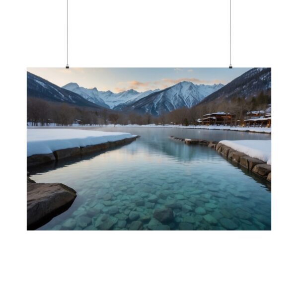 Tranquil mountain lake with clear water, snow-covered shores, and distant snow-capped peaks under a soft sky.