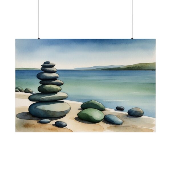 Stack of smooth stones on a serene beach by calm water, with distant hills and a clear sky.