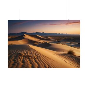 Expansive desert landscape with golden sand dunes at sunset, casting long shadows under a colorful sky with distant mountains.