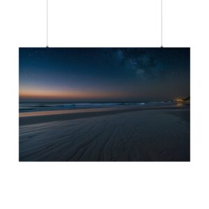 Calm beach at twilight with smooth sand, gentle waves, and the Milky Way visible in the starry night sky.