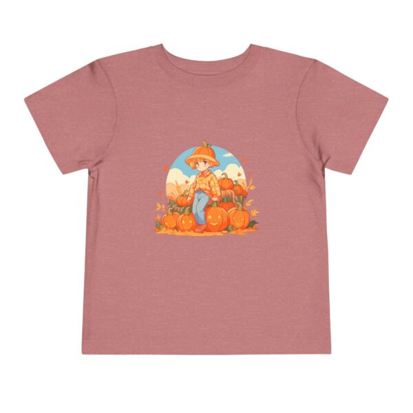 Pink toddler short sleeve tee with a fall scene illustration featuring a child with pumpkins