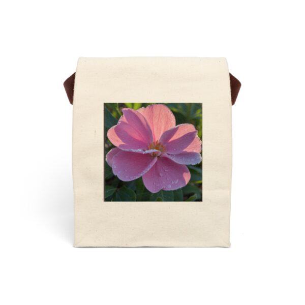 Canvas lunch bag with strap featuring a close-up of a single pink flower with dew