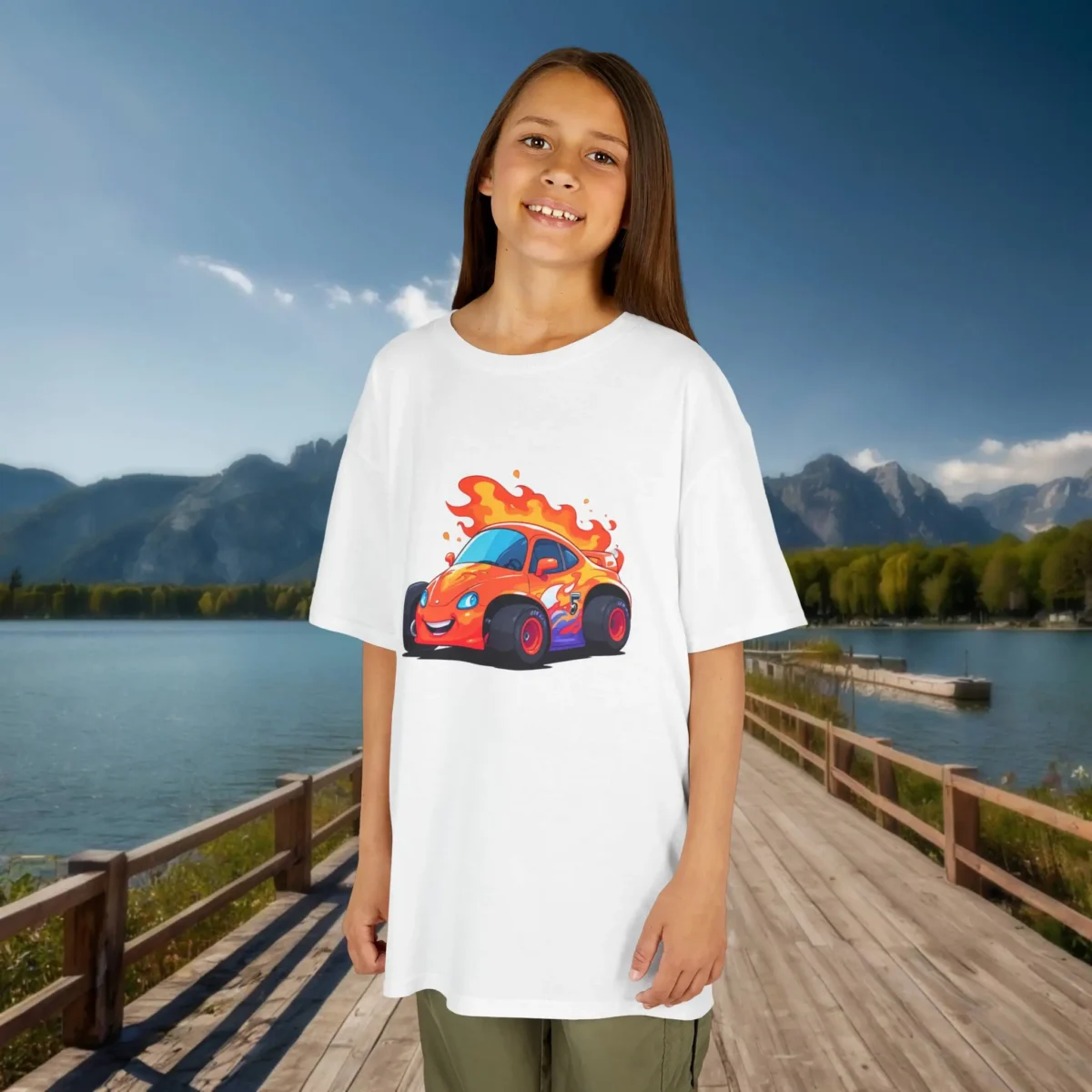 Girl wearing a white kids t-shirt featuring a flame-trailing cartoon race car in orange and purple tones.