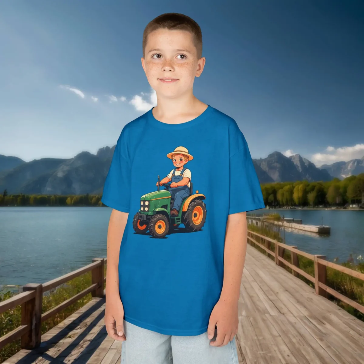 Boy wearing blue kids t-shirt with cartoon farmer driving a green tractor