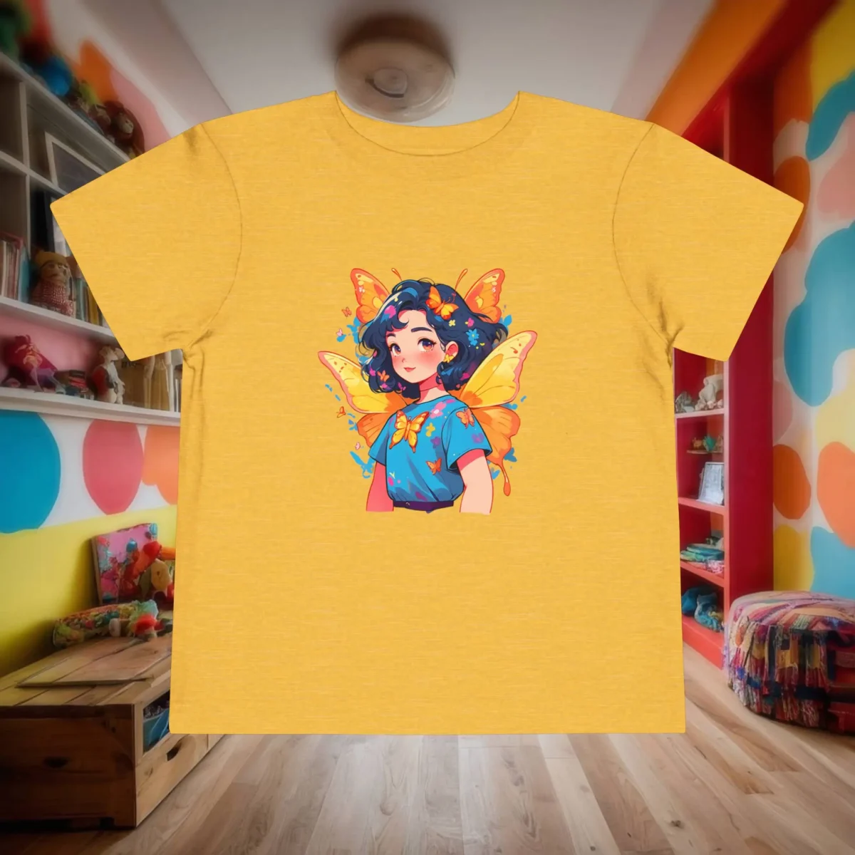 Flat lay of yellow toddler t-shirt with superheroine butterfly girl illustration.