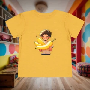 Flat lay of yellow toddler t-shirt featuring a cartoon boy holding three large bananas with a cheerful expression.